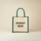 Jute bag with 'Emergency Snacks' text on a beige background - Green Trims