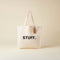 Tote bag with 'STUFF.' text on a beige background