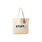 Beige tote bag with 'STUFF.' text and a tag on a white background