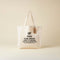 Tote bag with humorous text on a beige background